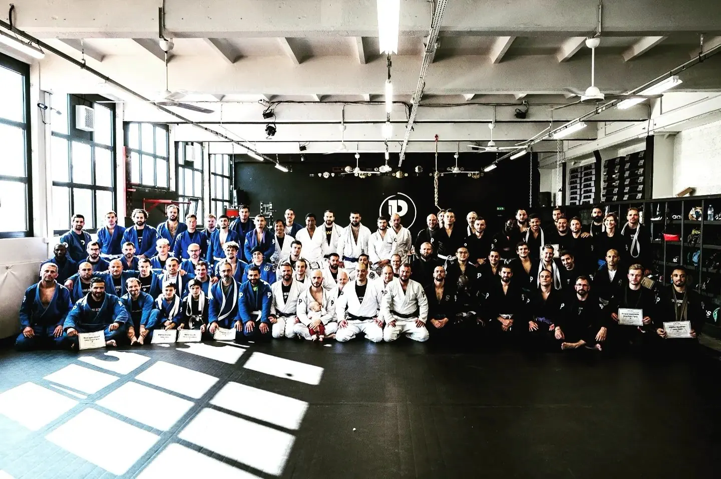 Photo de groupe d'un passage de grade, élèves assis et debout avec leurs diplômes